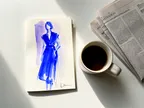 Akvarel af modeskitse, kaffekop og avis